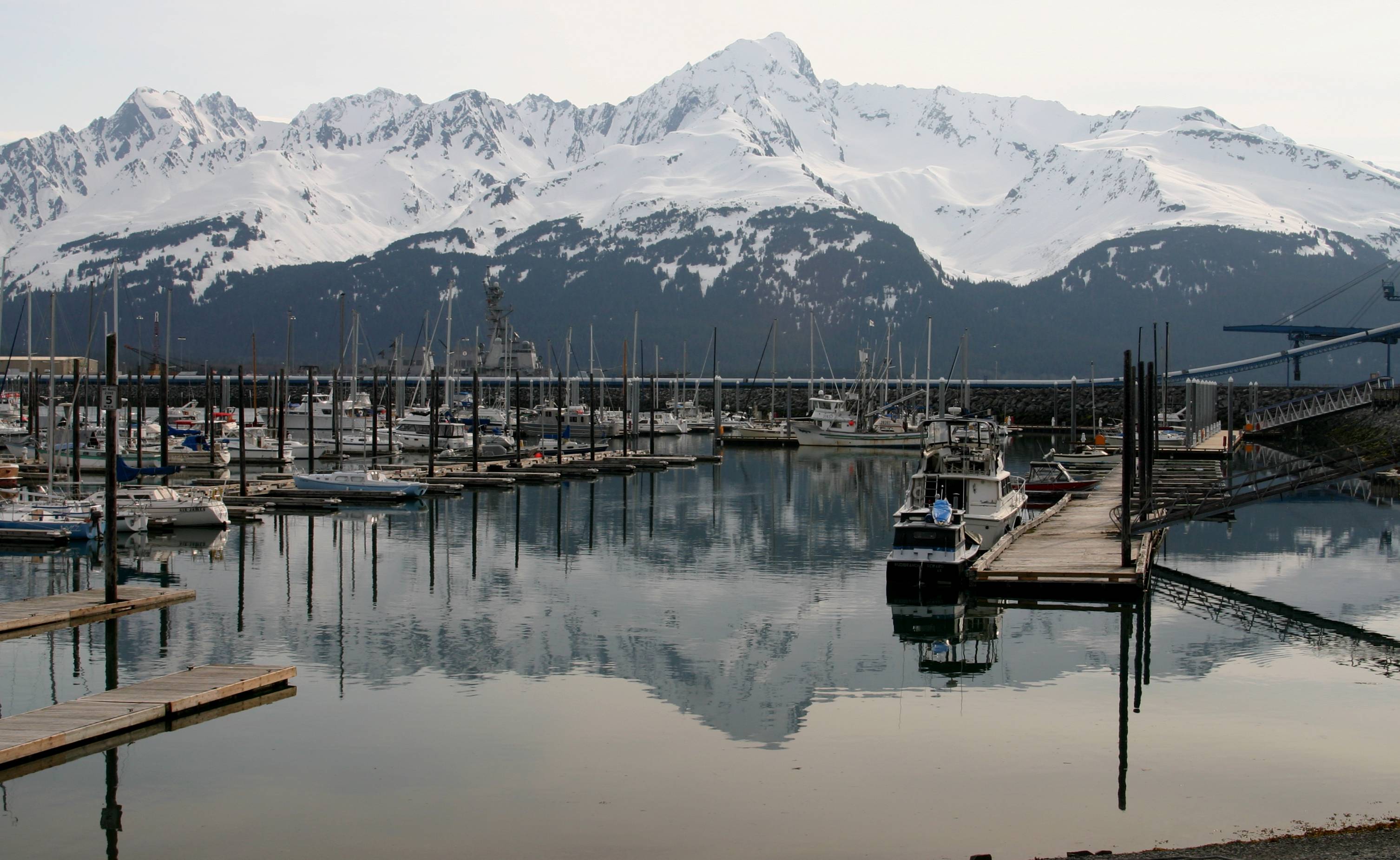 Boats in Seward Harbor beneath snow-covered mountains